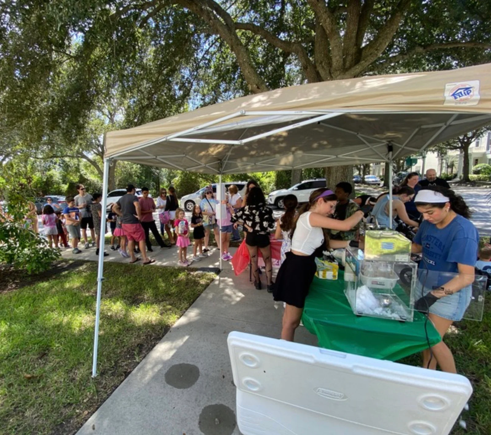 Two young girls sitting at a table building a robotic model.